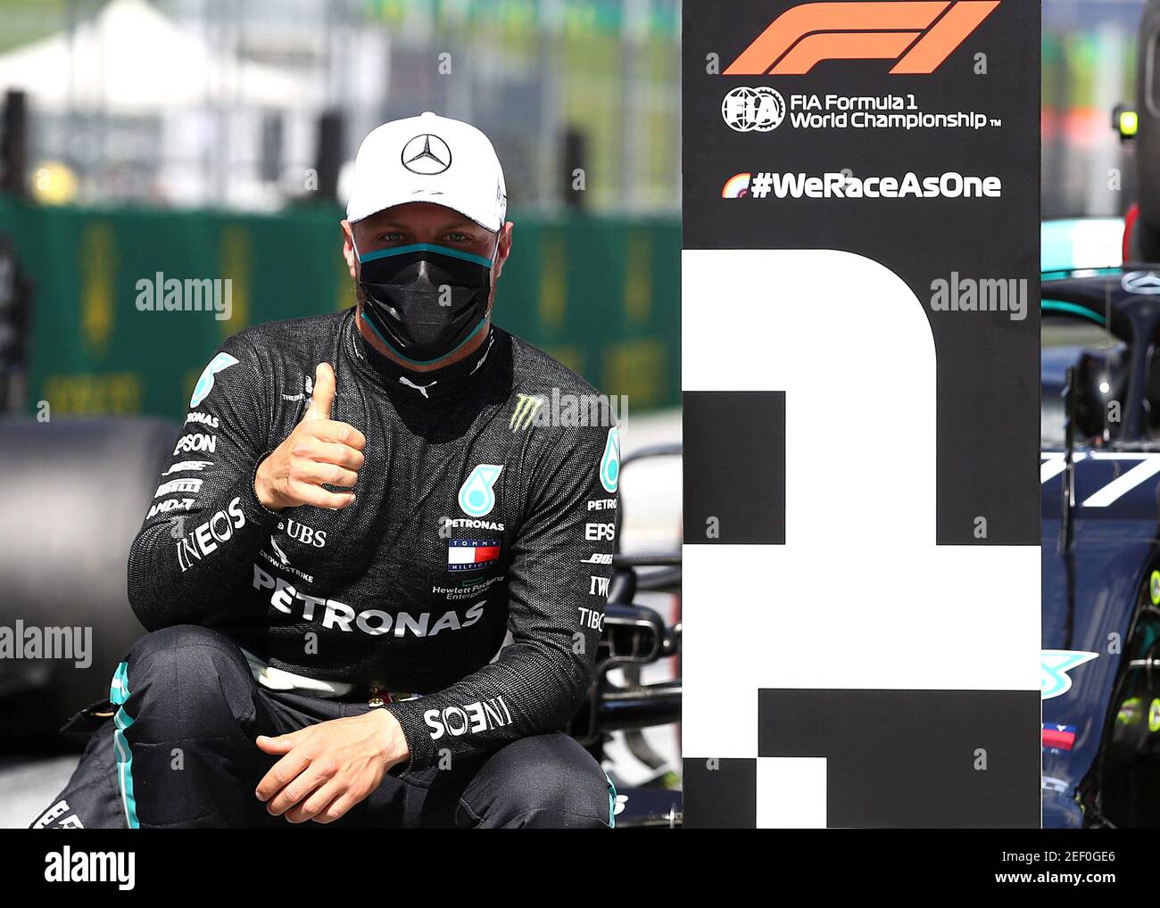 Formula One F1 - Austrian Grand Prix - Red Bull Ring, Spielberg, Styria, Austria - July 4, 2020   Mercedes' Valtteri Bottas wearing a protective face mask celebrates after qualifying in pole position, as F1 resumes following the outbreak of the coronavirus disease (COVID-19)   Mark Thompson/Pool via REUTERS Stock Photo