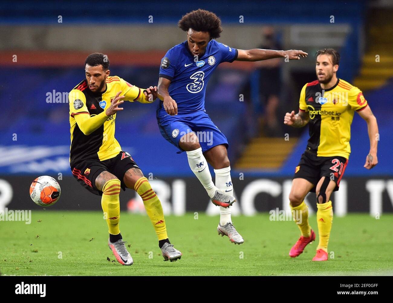 Soccer Football - Premier League - Chelsea v Watford - Stamford Bridge, London, Britain - July 4, 2020  Chelsea's Willian in action with Watford's Etienne Capoue, as play resumes behind closed doors following the outbreak of the coronavirus disease (COVID-19) Glyn Kirk/Pool via REUTERS  EDITORIAL USE ONLY. No use with unauthorized audio, video, data, fixture lists, club/league logos or 'live' services. Online in-match use limited to 75 images, no video emulation. No use in betting, games or single club/league/player publications.  Please contact your account representative for further details. Stock Photo
