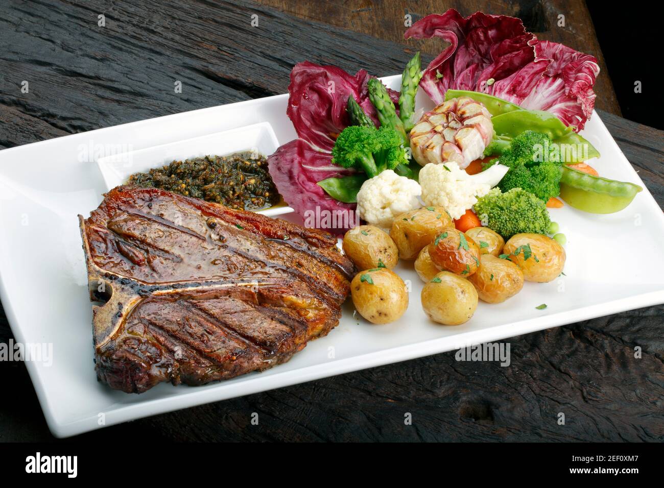 t bone steak with potato salad and vegetables Stock Photo - Alamy
