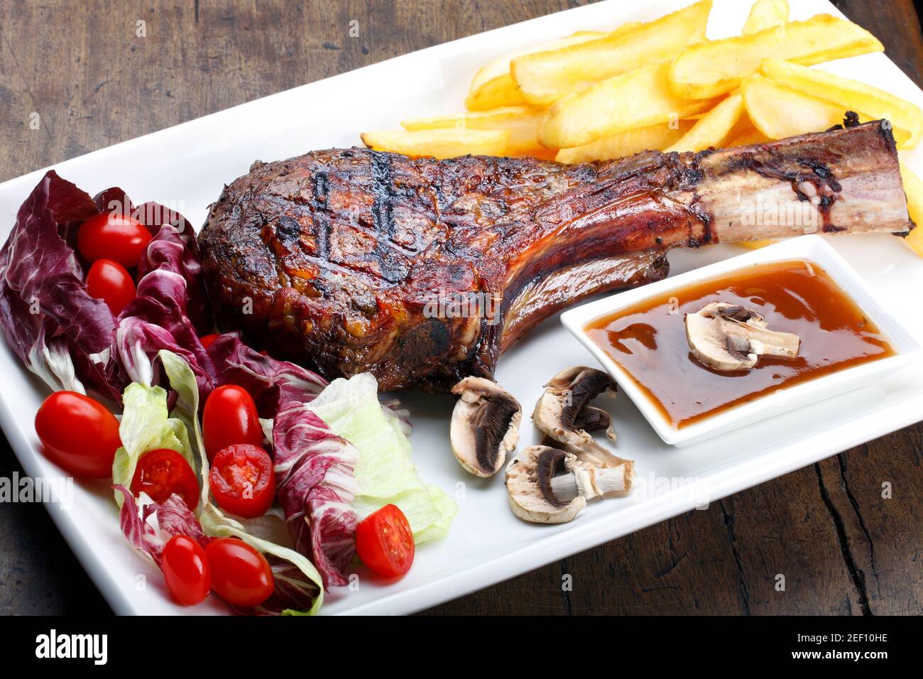 t bone steak with potato salad and vegetables Stock Photo - Alamy