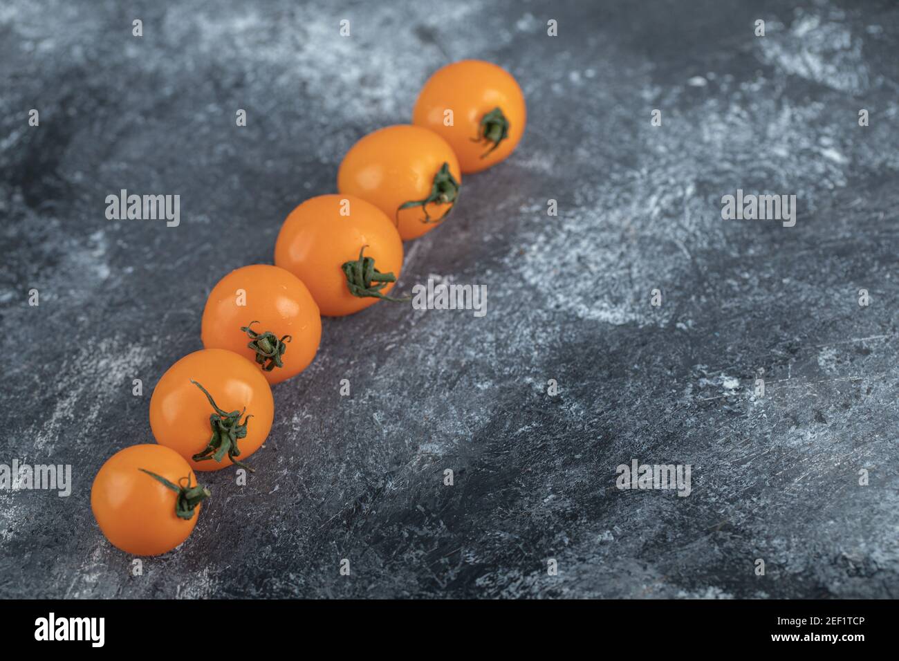 Fresh organic cherry tomatoes in a row Stock Photo