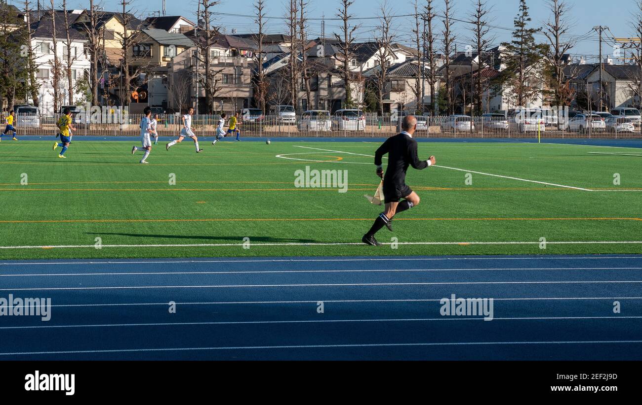 A football referee manages a game of football in Nerima City, Tokyo, Japan. Stock Photo