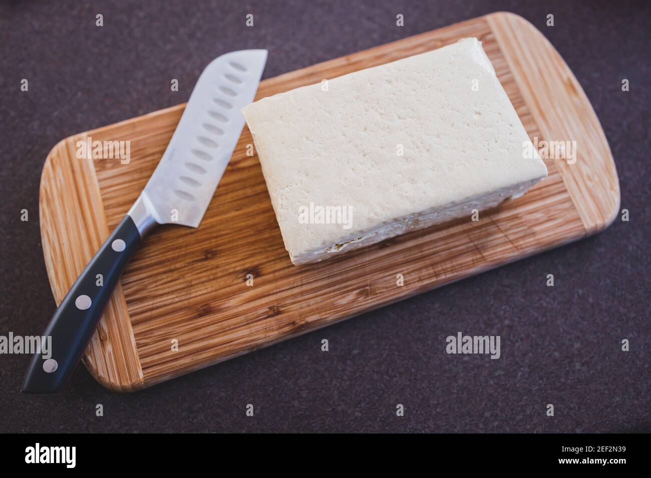 simple food ingredients concept, block of extra firm tofu on cutting