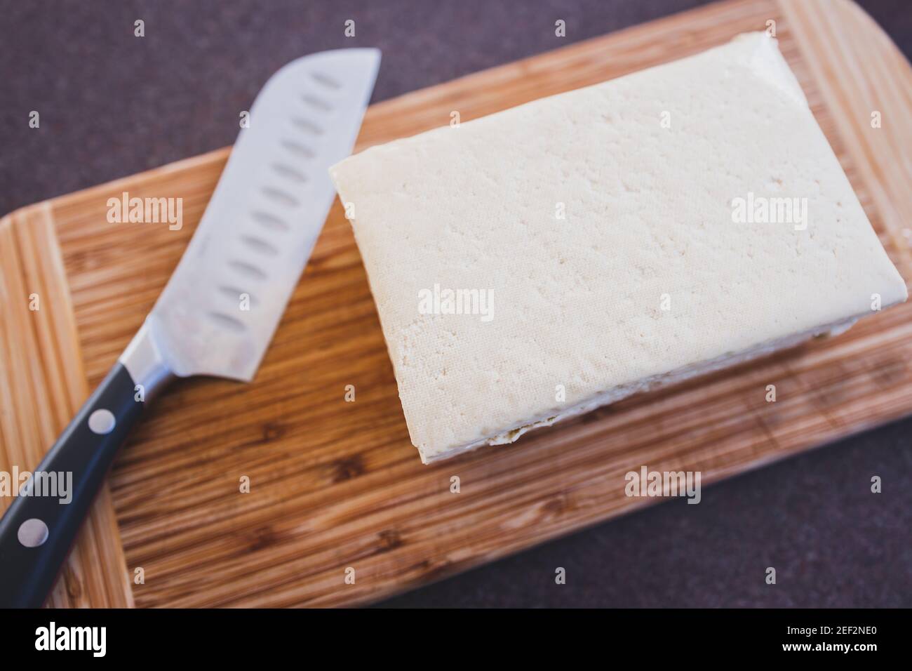 simple food ingredients concept, block of extra firm tofu on cutting