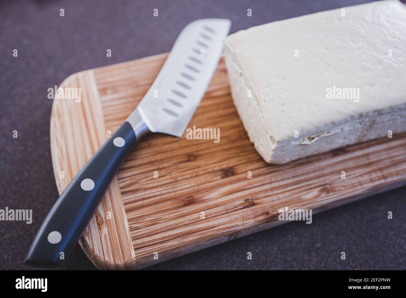 simple food ingredients concept, block of extra firm tofu on cutting
