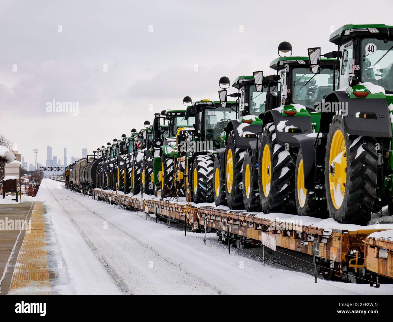 Railroad flatcars loaded with John Deere tractors for export. Oak Park, Illinois. Downtown
