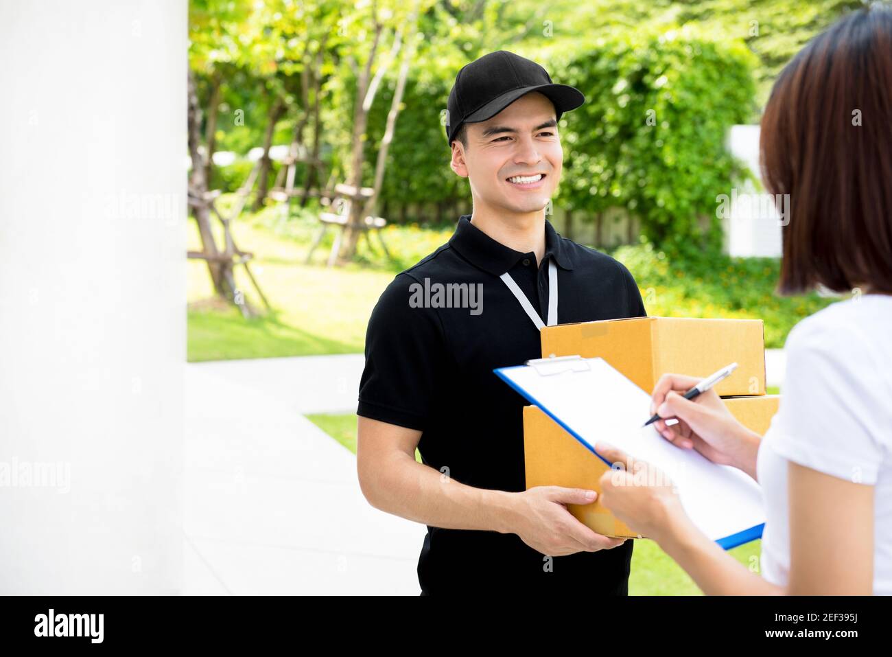 Black delivery man holding package hi-res stock photography and images ...
