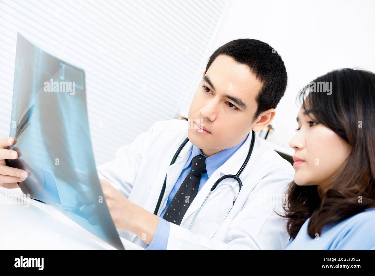 Doctor showing x-ray image to woman patient Stock Photo