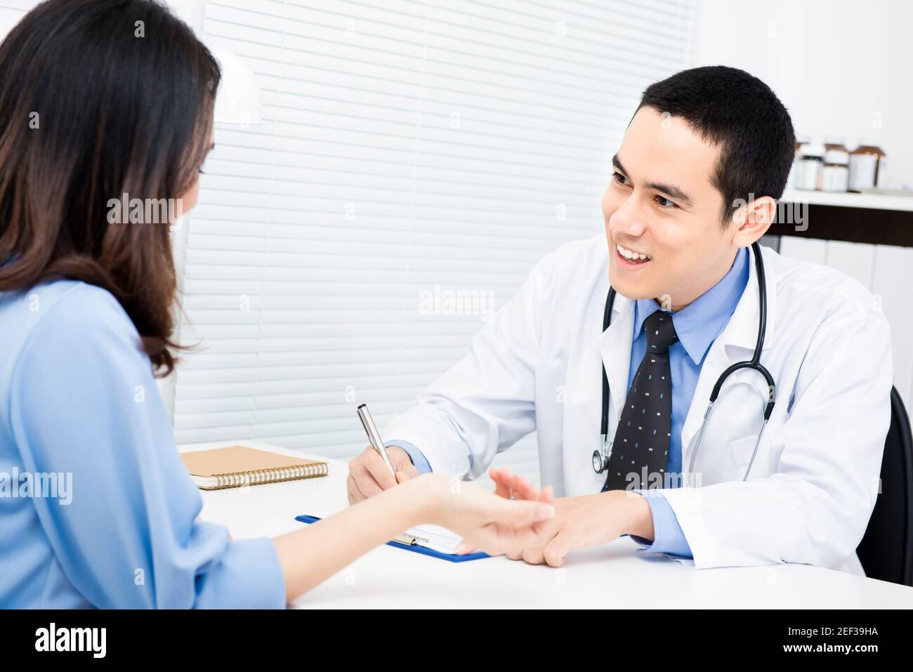 Doctor asking some information from female patient Stock Photo