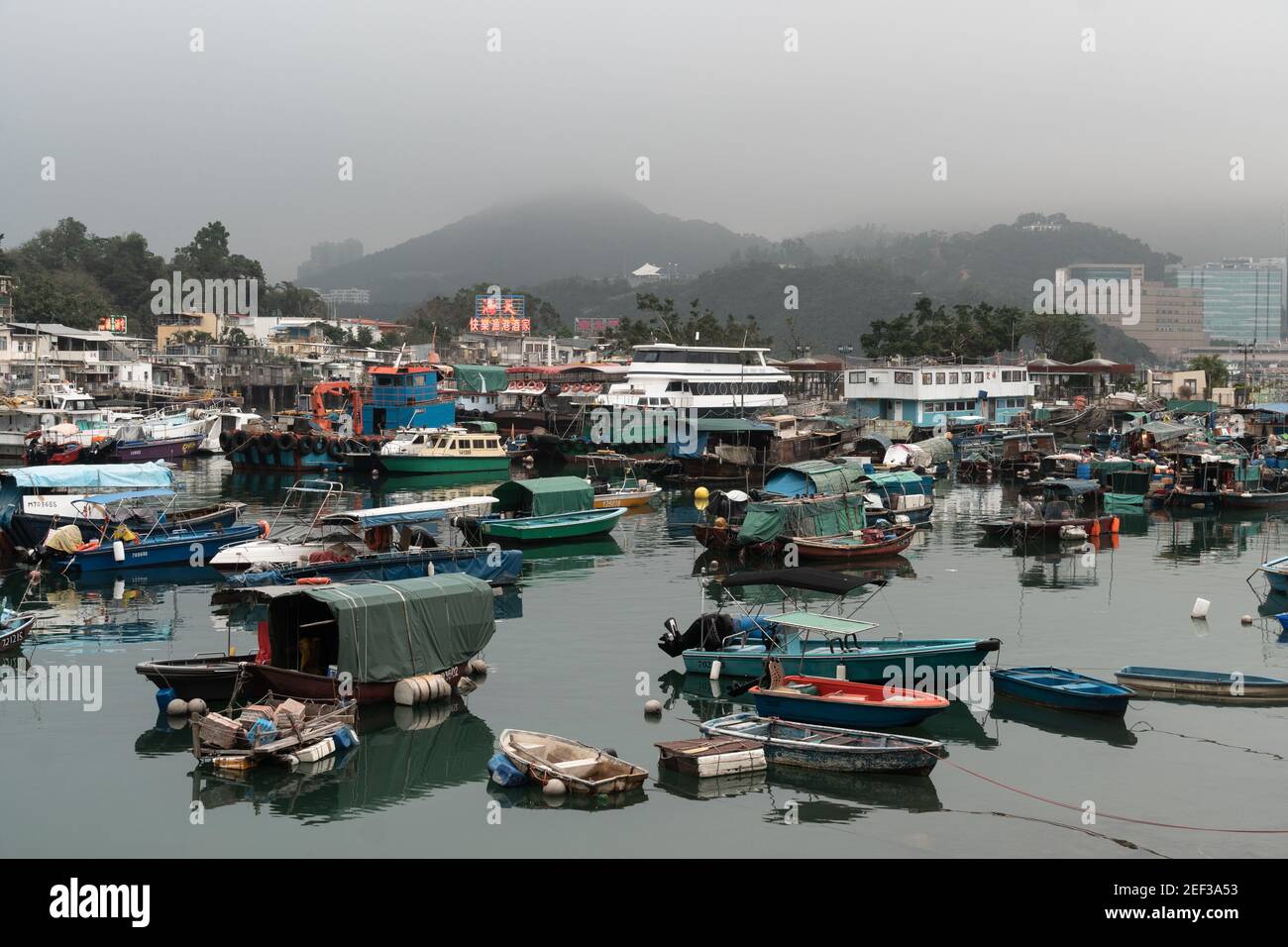 Yau Tong, Hong Kong - March 15 2019: Boats in the Sam Ka Tsuen typhoon shelter harbor face the Lei Yue Mun fishing village famous for its seafood rest Stock Photo