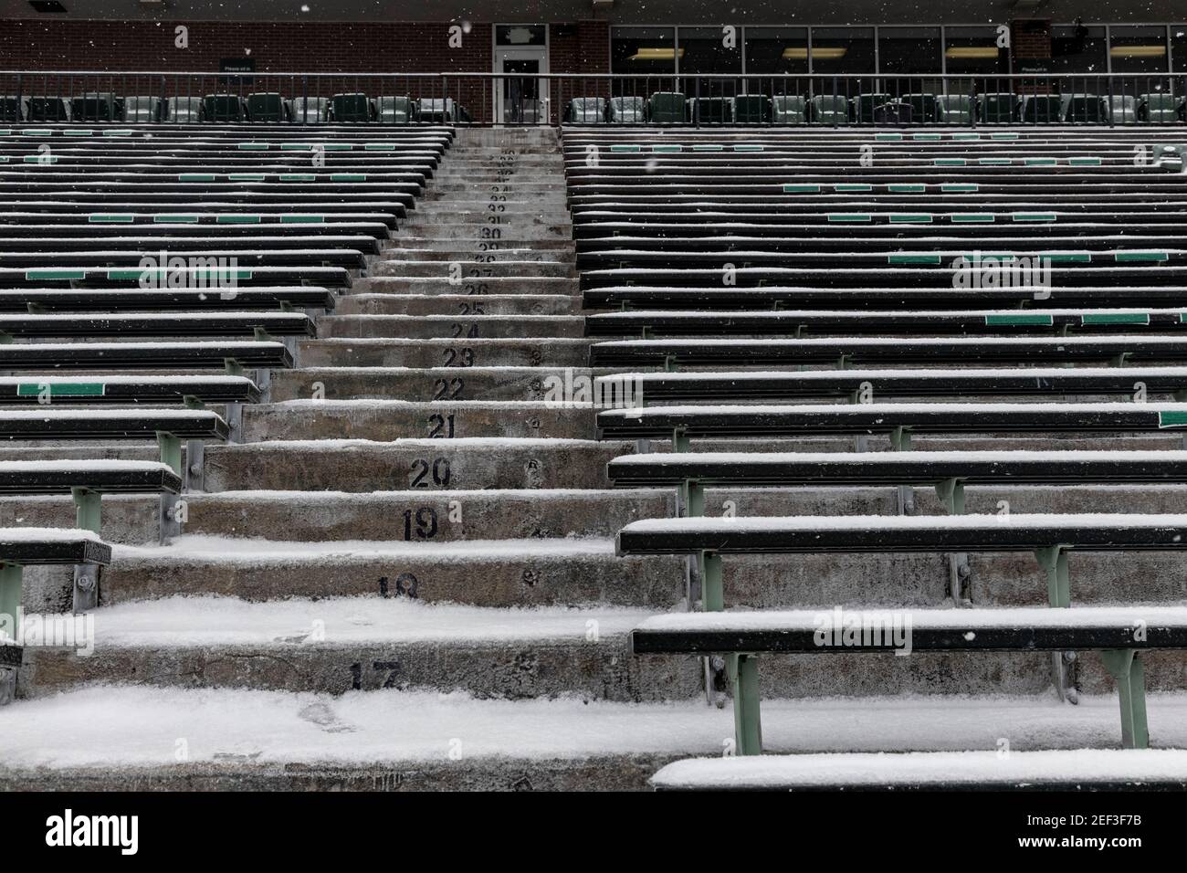 Steps and bleachers of Peden Stadium are covered with snow.Snowstorm Uri swept across the United States from February 12th to the 16th covering the United States in snow and Ice. Uri begun in the Pacific Northwest, and headed all the way to the southeast of US. The storm has claimed many lives due to car accidents and low temperatures. In Athens County Ohio the storm began on Monday morning February 15, 2021 and has continued into Tuesday 16, 2021. Currently Athens County is under a level two snow emergency. Stock Photo