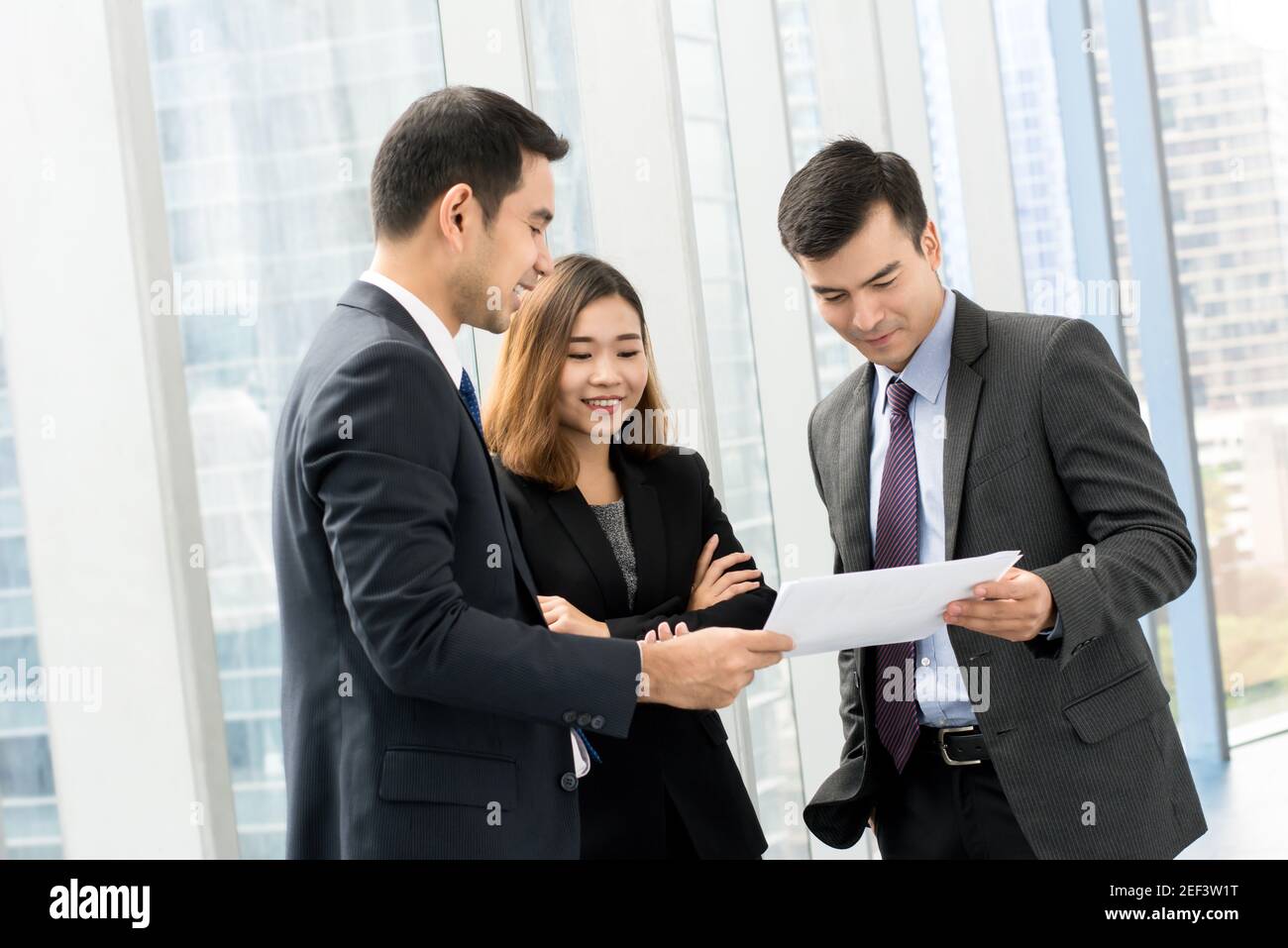 Group of business people discussing work at building hallway Stock Photo