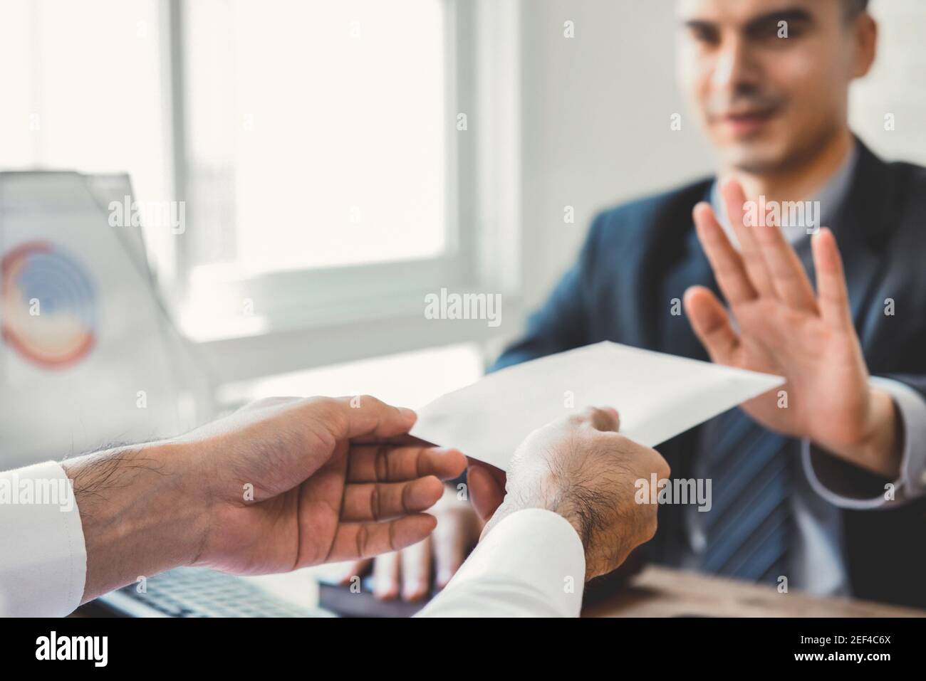 Businessman refusing money in the envelope - anti bribery and corruption concepts Stock Photo
