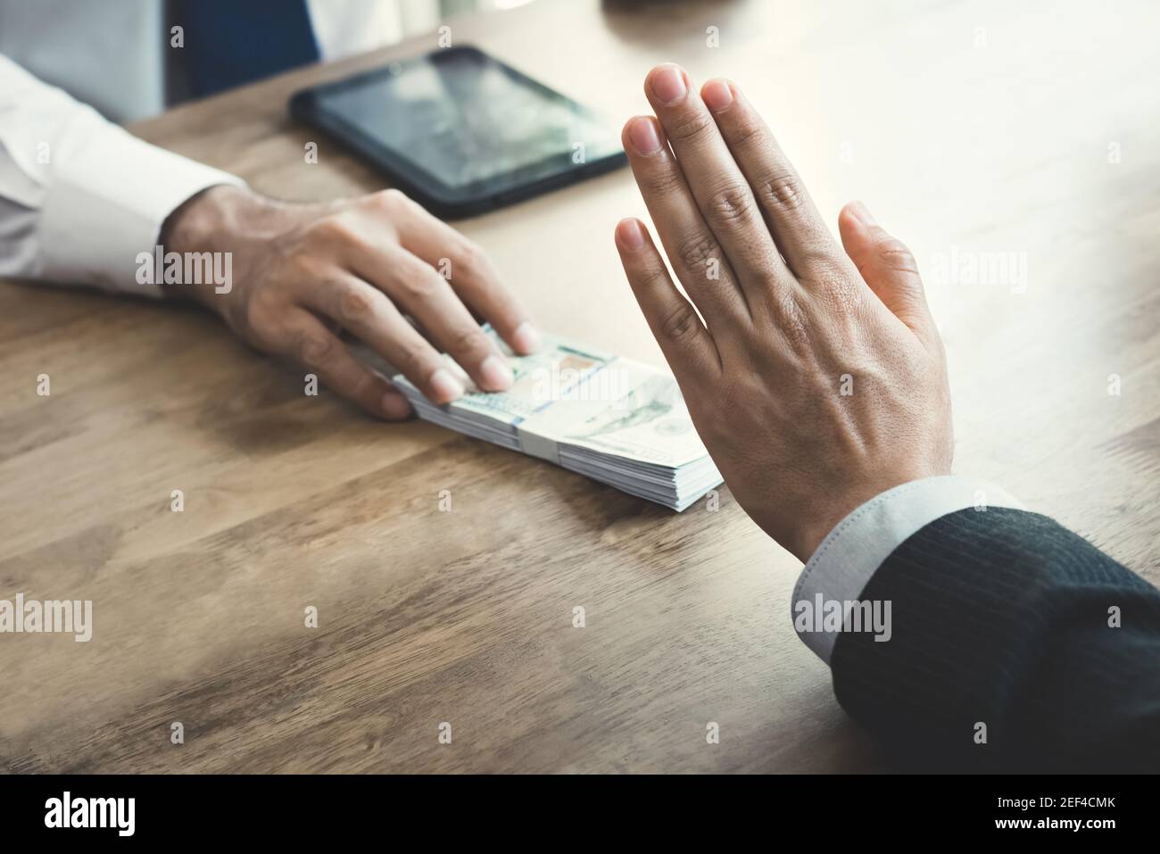 Businessman rejecting money that offered by a man- anti bribery and corruption concept Stock Photo