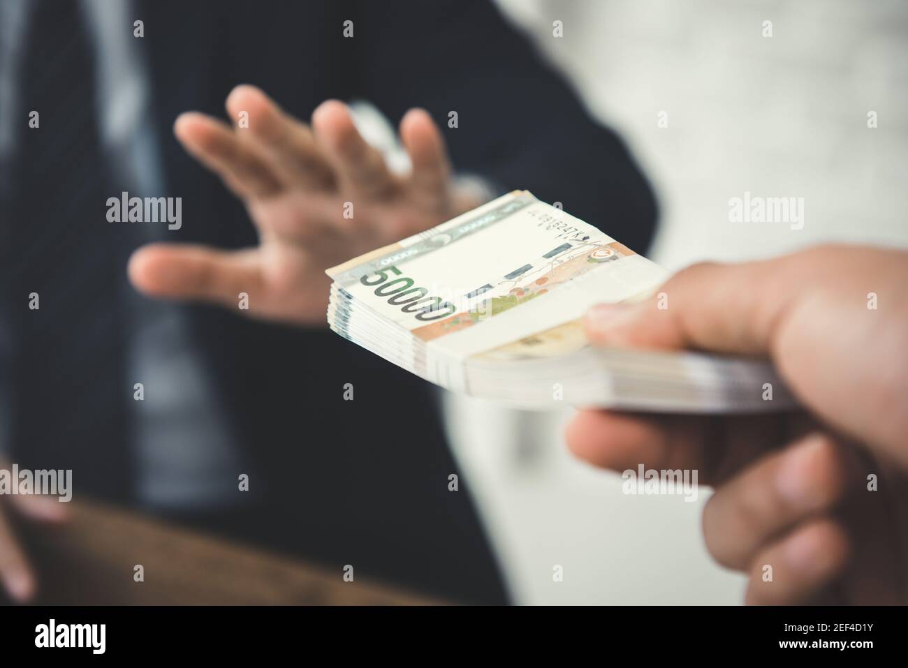 Businessman refusing money, South Korean won bills - anti bribery and corruption concepts Stock Photo