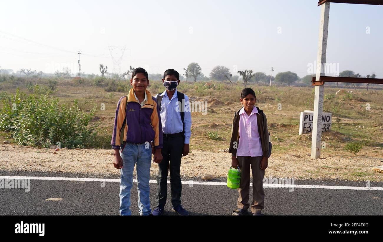 10 February 2021- Sikar, Jaipur, India. Three little Indian kid going to school in the morning time with Tiffin box. School open concept after covid 1 Stock Photo