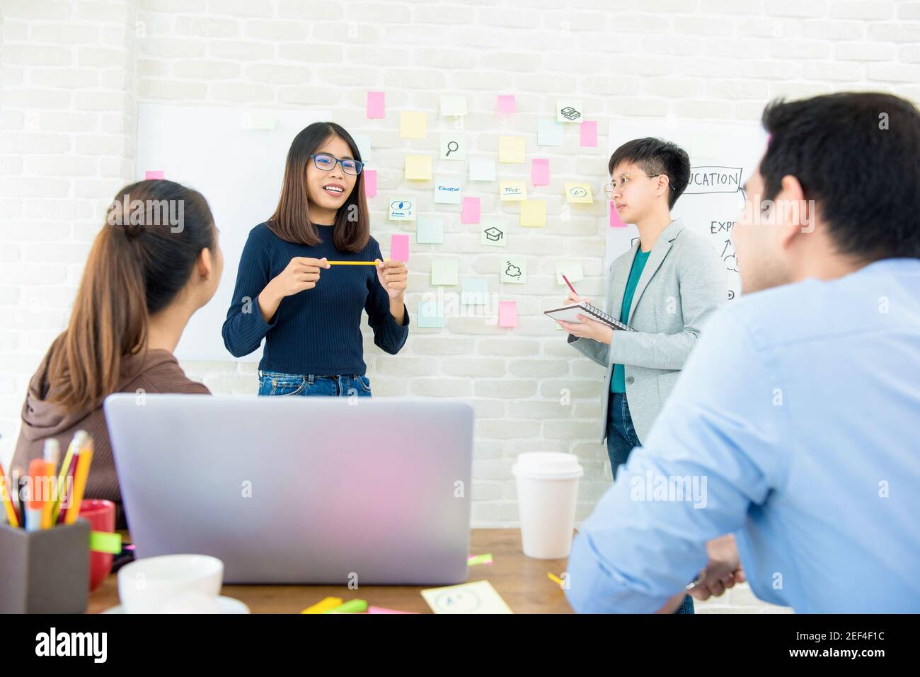 Group of Asian woman students presenting and discussing project in classroom Stock Photo