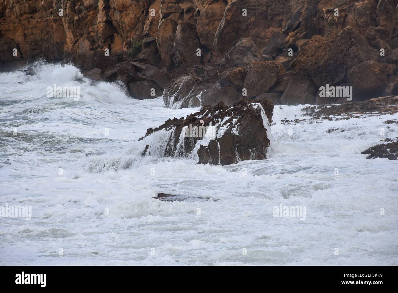 beautiful waves crashing on rocks Stock Photo