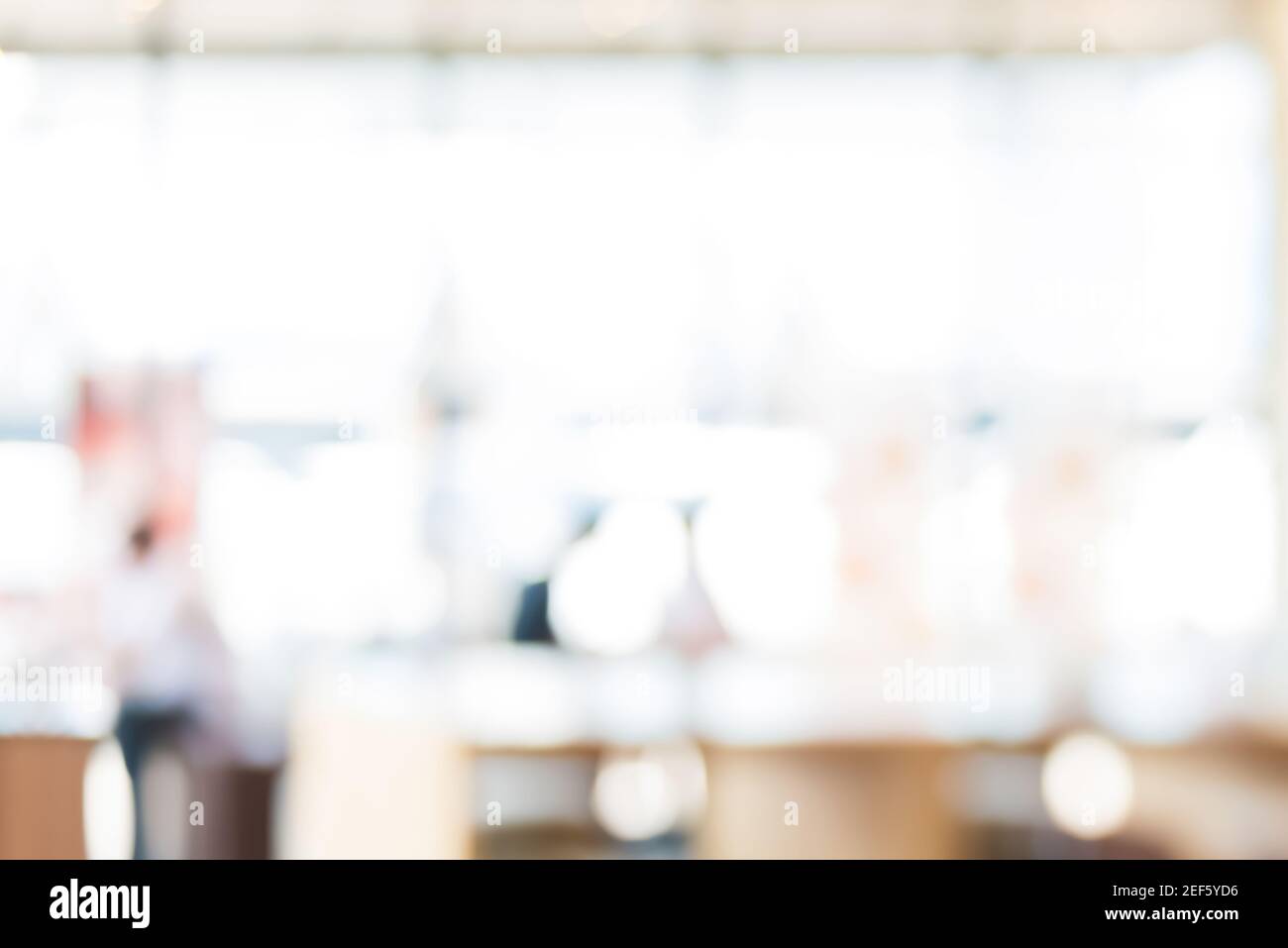 Abstract blur white bokeh background from restaurant interior Stock Photo