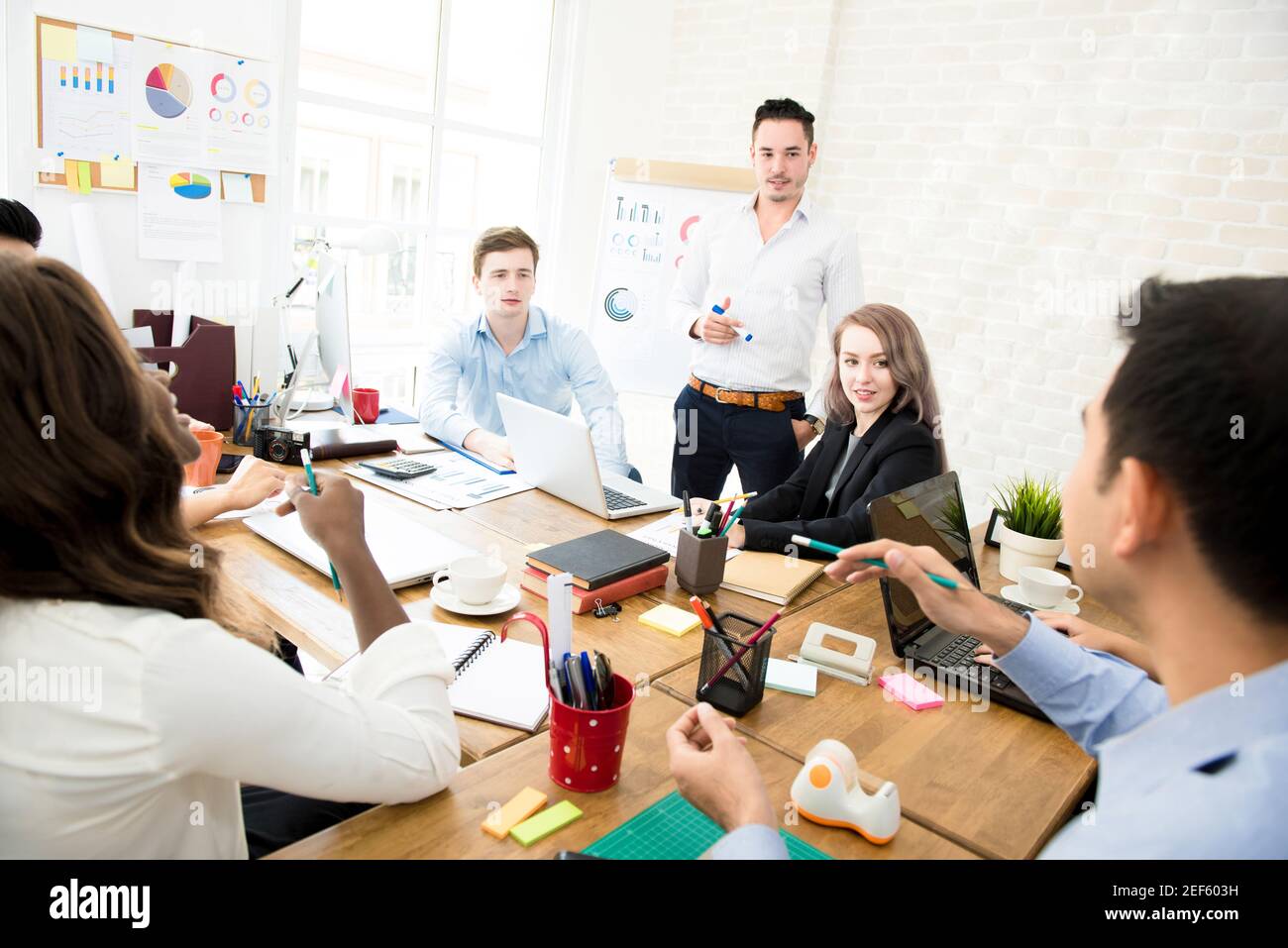 Group of multiethnic casual business people discussing work in co-working space Stock Photo