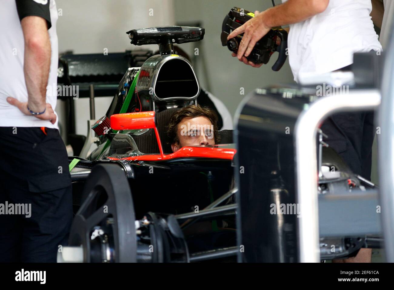 Formula One - F1 - Malaysian Grand Prix 2015 - Sepang International Circuit, Kuala Lumpur, Malaysia - 26/3/15  McLaren's Fernando Alonso sits in his car in the team garage  Reuters / Olivia Harris  Livepic Stock Photo