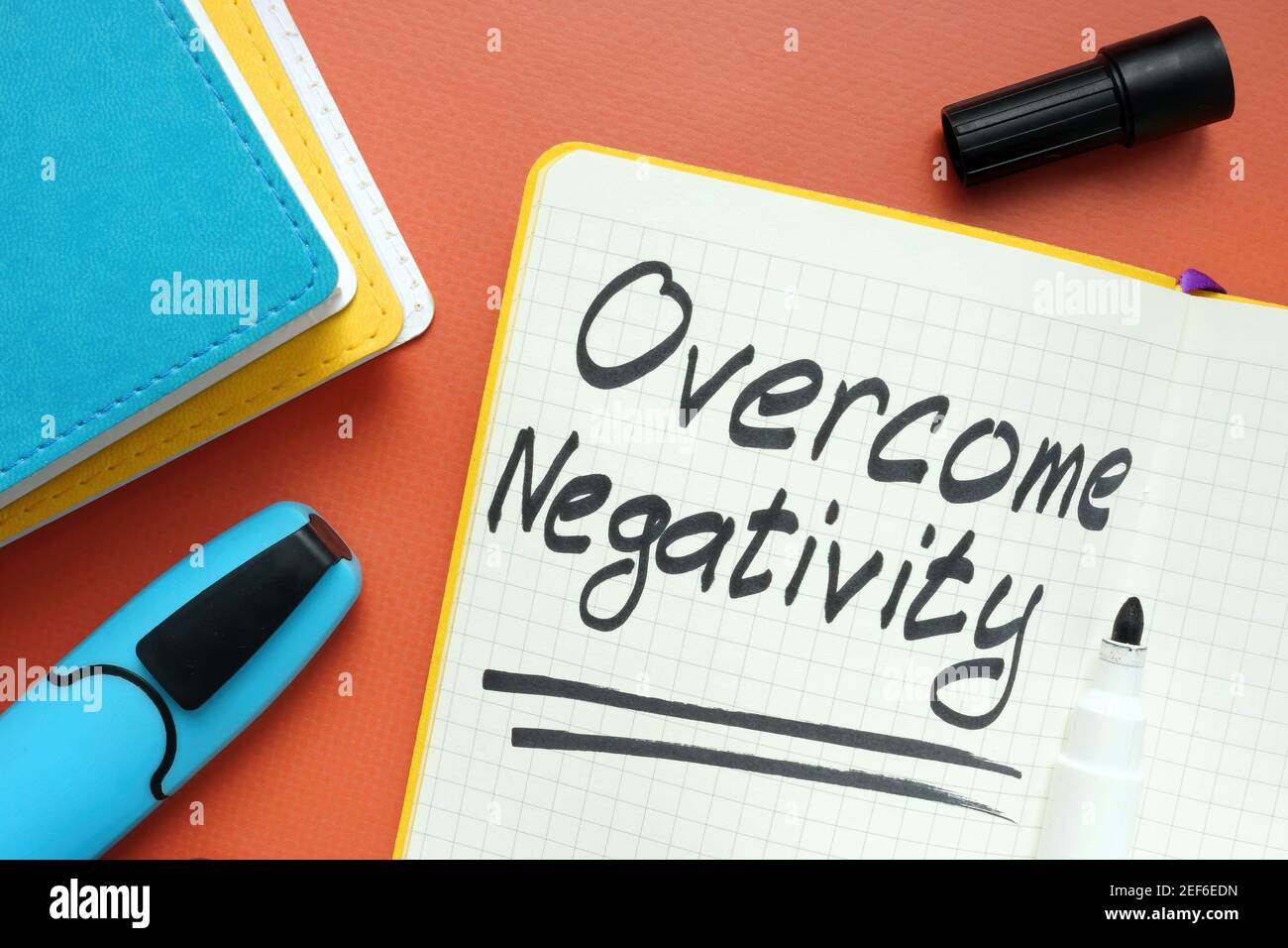 Overcome negativity handwritten memo on the page and marker. Stock Photo