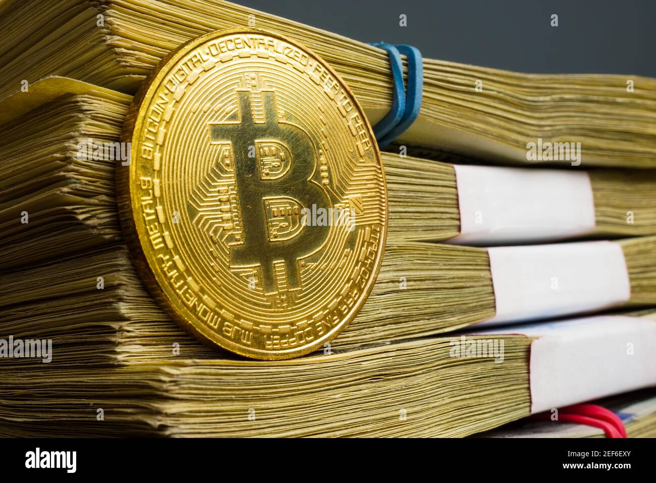 Bitcoin btc cost concept. Cryptocurrency coin and stack of money. Stock Photo