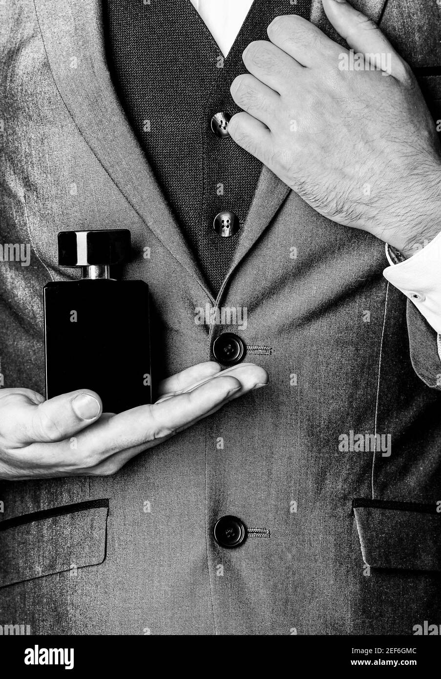 Fragrance smell. Men perfumes. Fashion cologne bottle. Man holding up