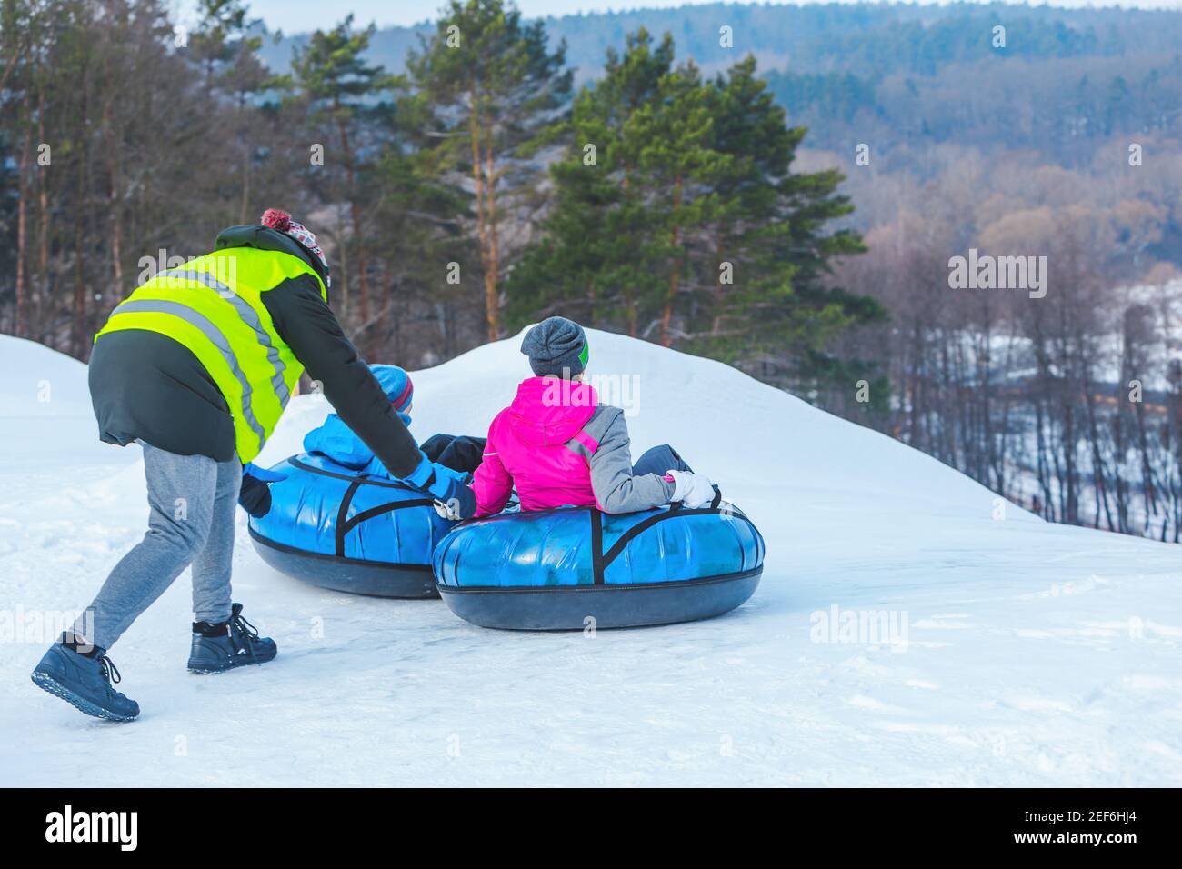 people riding snow tubing at winter park copy space Stock Photo - Alamy