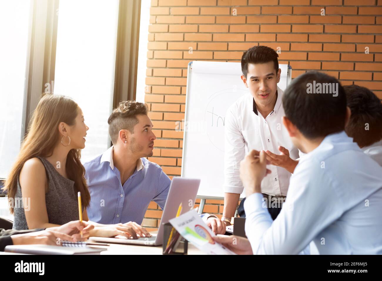 Multiethnic casual business team in meeting room Stock Photo