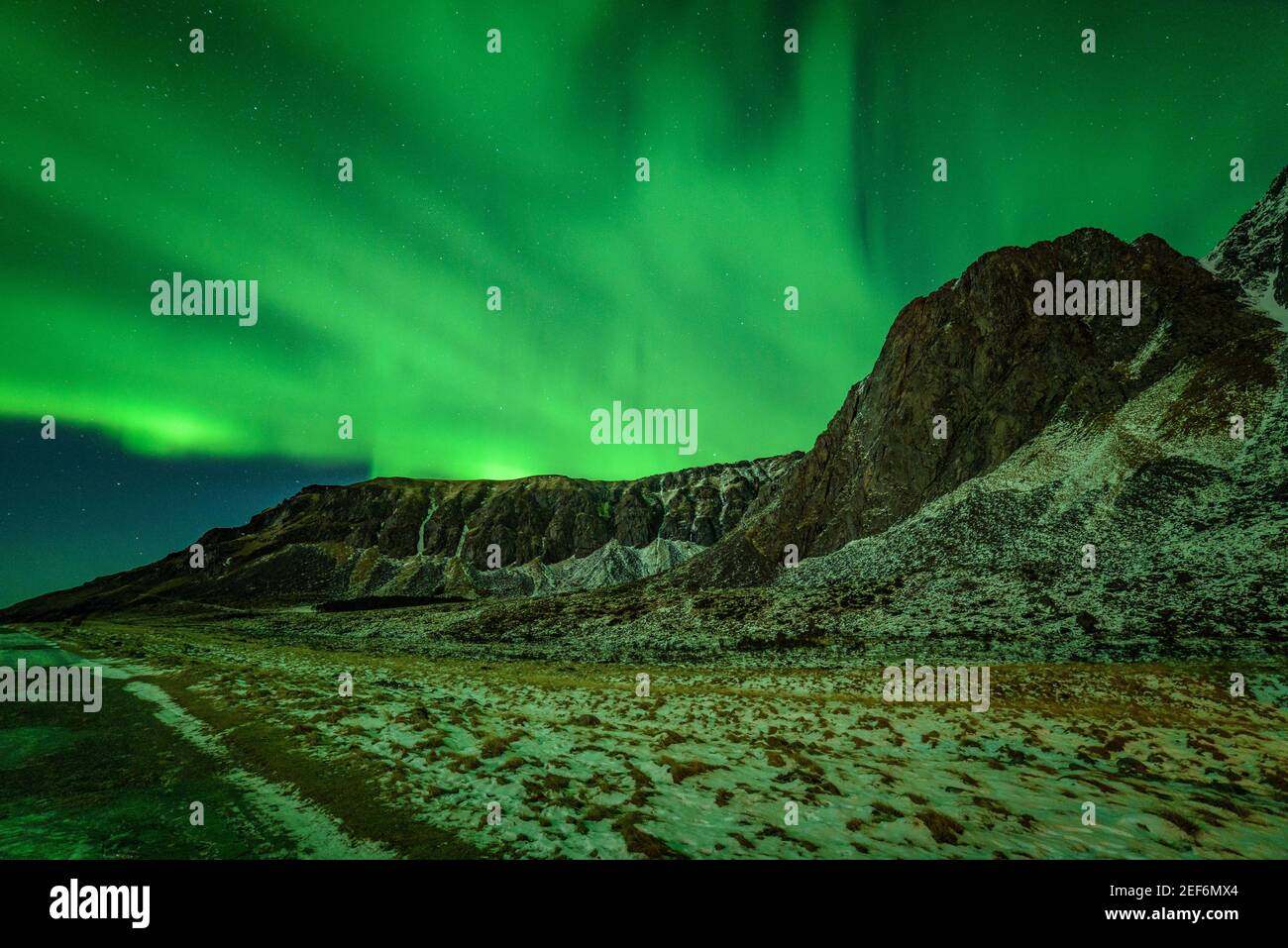 Northern lights in Unstad Beach (Lofoten, Norway) ESP: Auroras boreales invernales en la playa de Unstad Beach (Lofoten, Noruega) Stock Photo