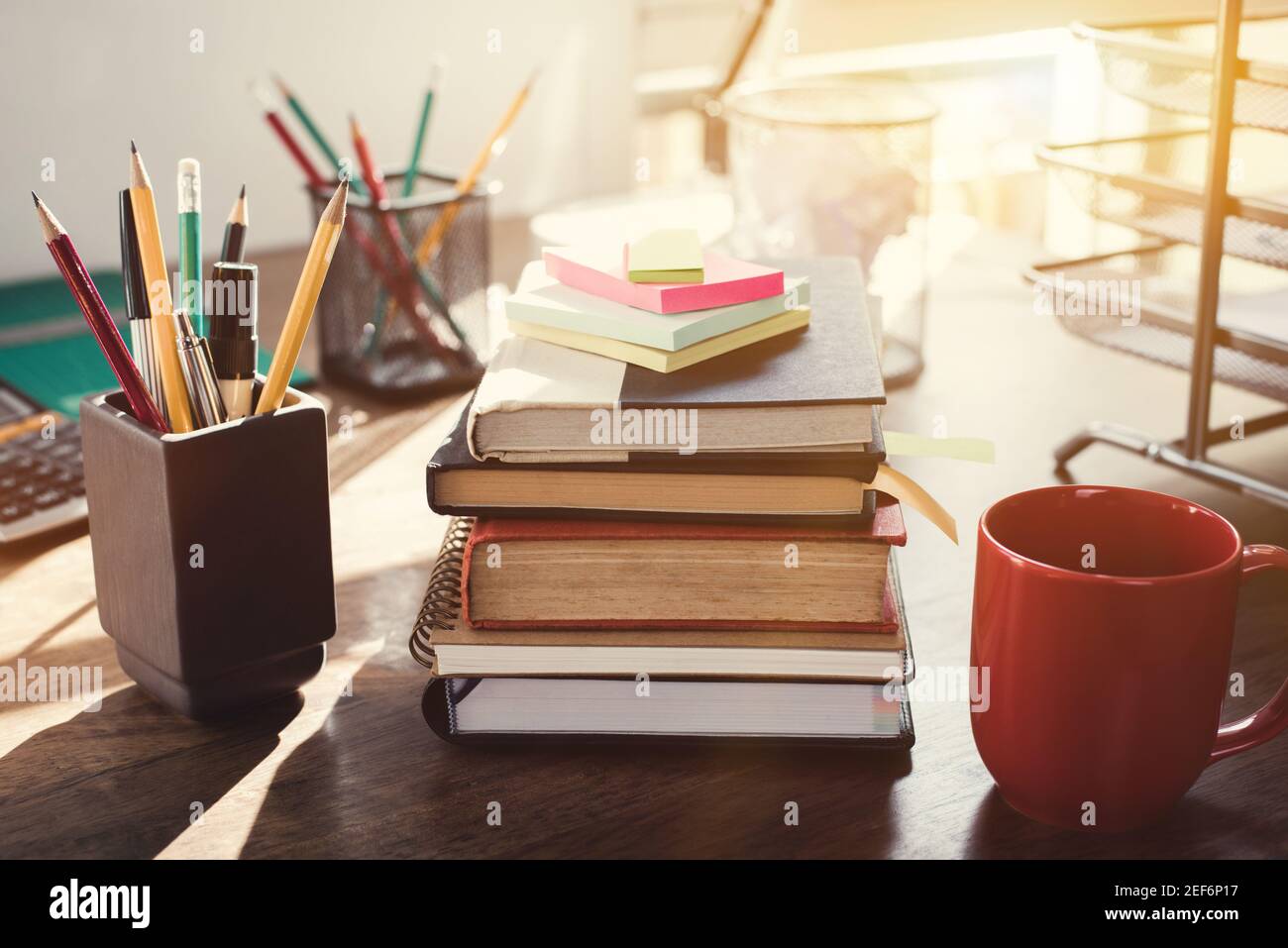 Stack of books and stationery on the desk - vintage tone effect Stock Photo