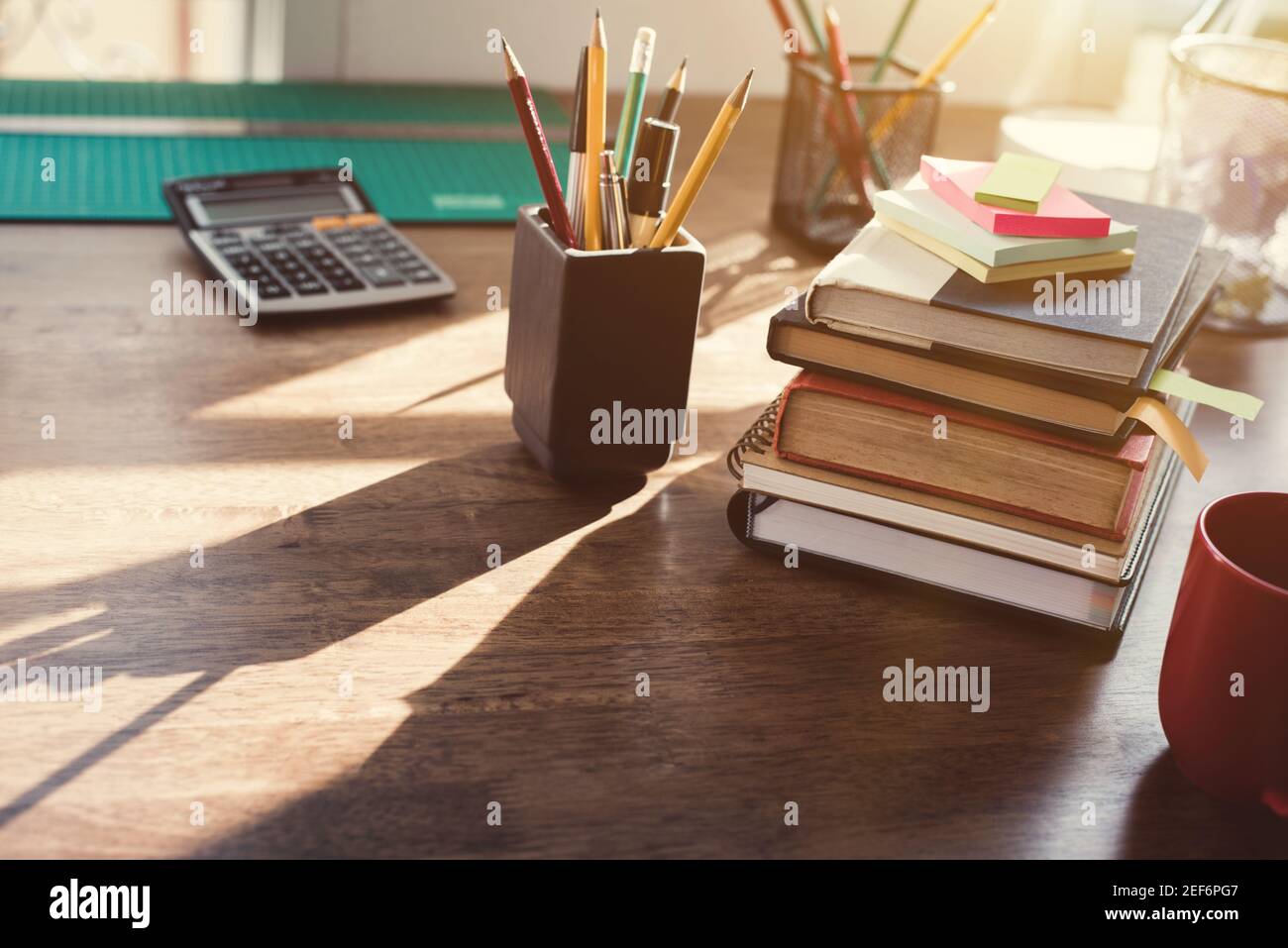 https://c8.alamy.com/comp/2EF6PG7/stack-of-books-and-stationery-on-the-desk-vintage-tone-effect-2EF6PG7.jpg