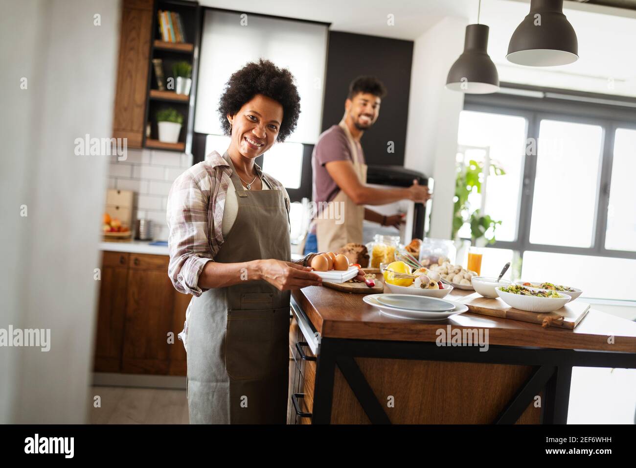 Funny young housewife cooking in kitchen Stock Photo - Alamy