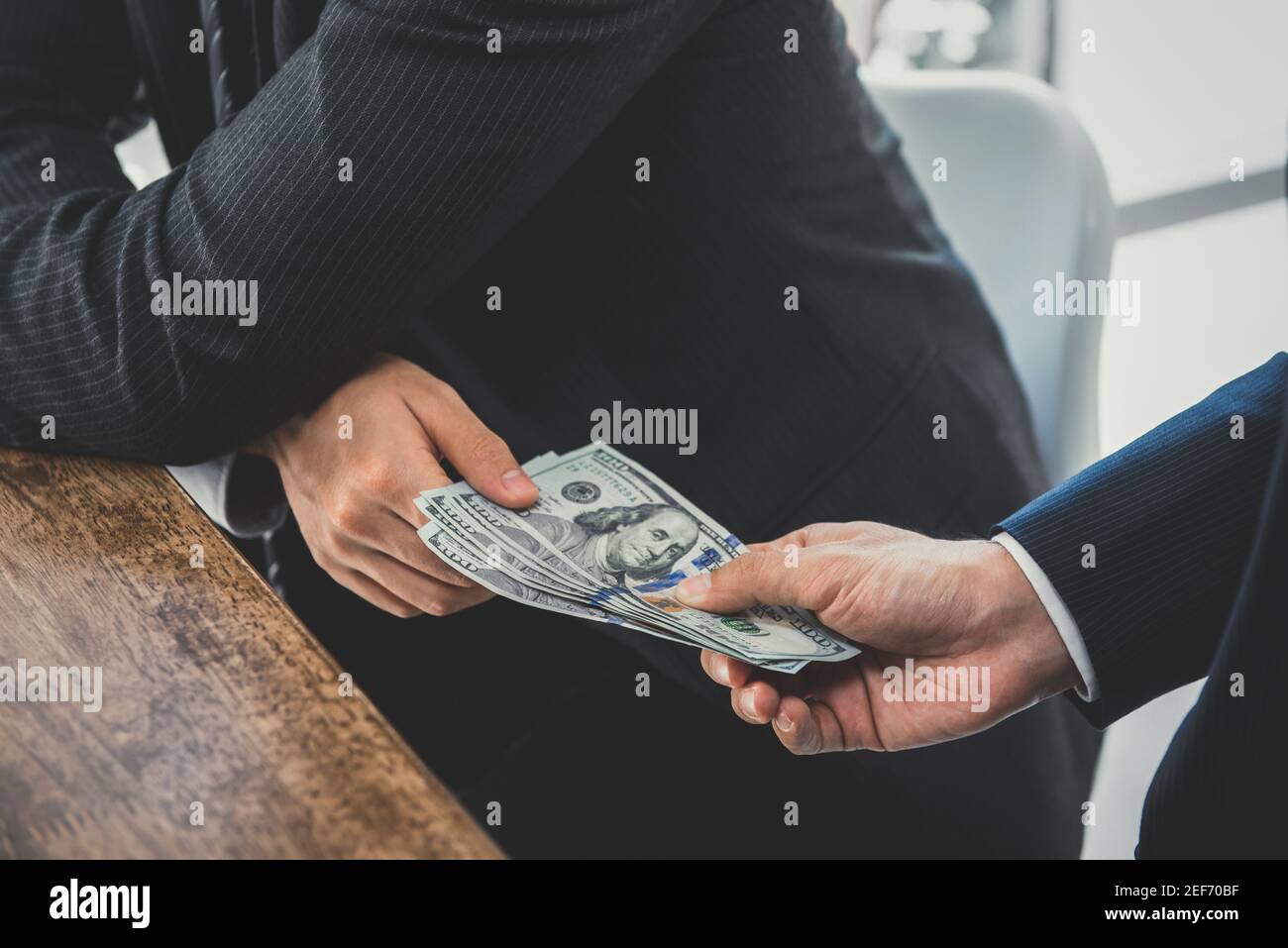 Businessmen secretly passing money - bribery and corruption concepts Stock Photo
