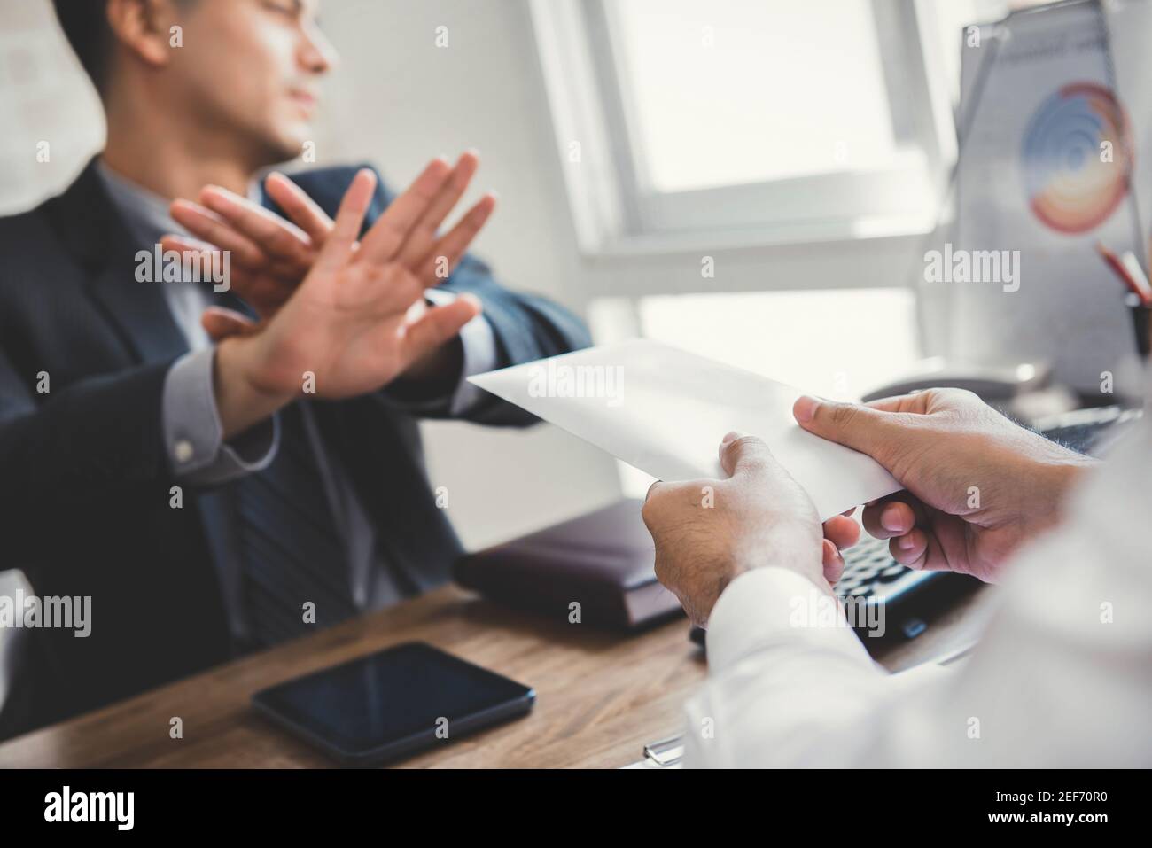 Businessman refusing money in the envelope - anti bribery and corruption concepts Stock Photo