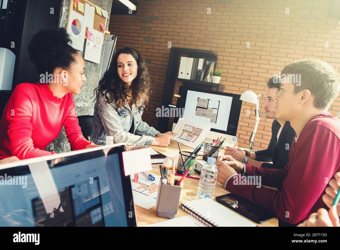 Young casual multiethnic creative team at the meeting of interior design company - teamwork and brainstorming concepts Stock Photo