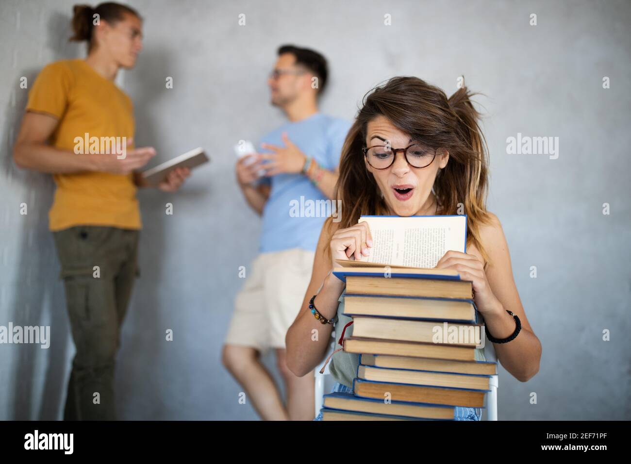 Stylish nerd girl with many books. Education, study, people, university concept. Stock Photo