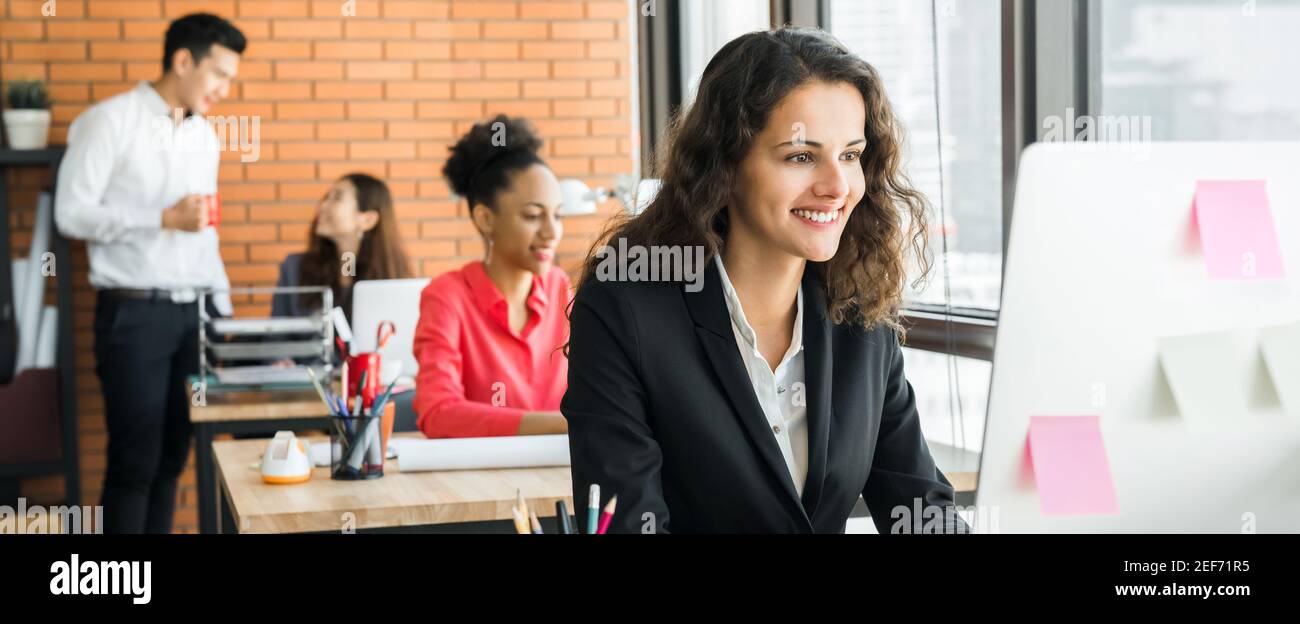 Businesswoman working in creative office with multiethnic colleagues, panoramic banner Stock Photo