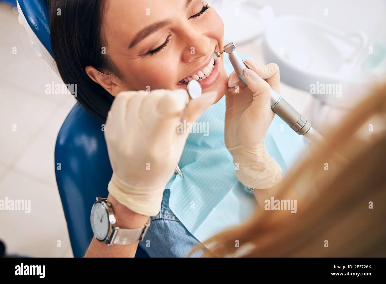 Focused photo on female hand that using drill machine Stock Photo