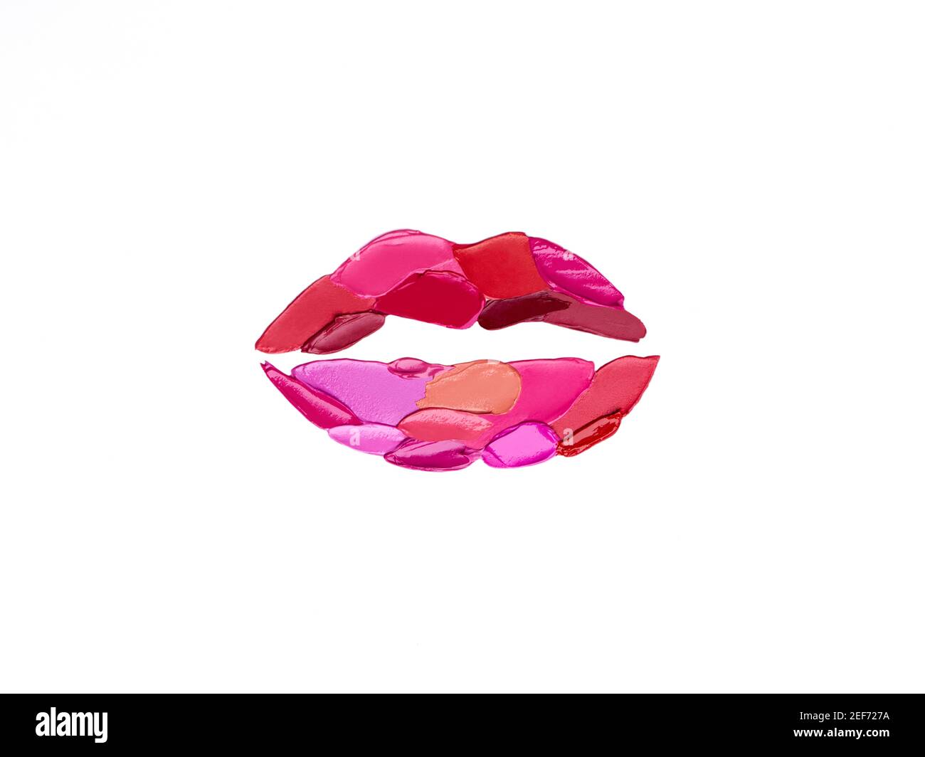 Red and pink lipstick smeared in the shape of lips. Isolated on white background Stock Photo