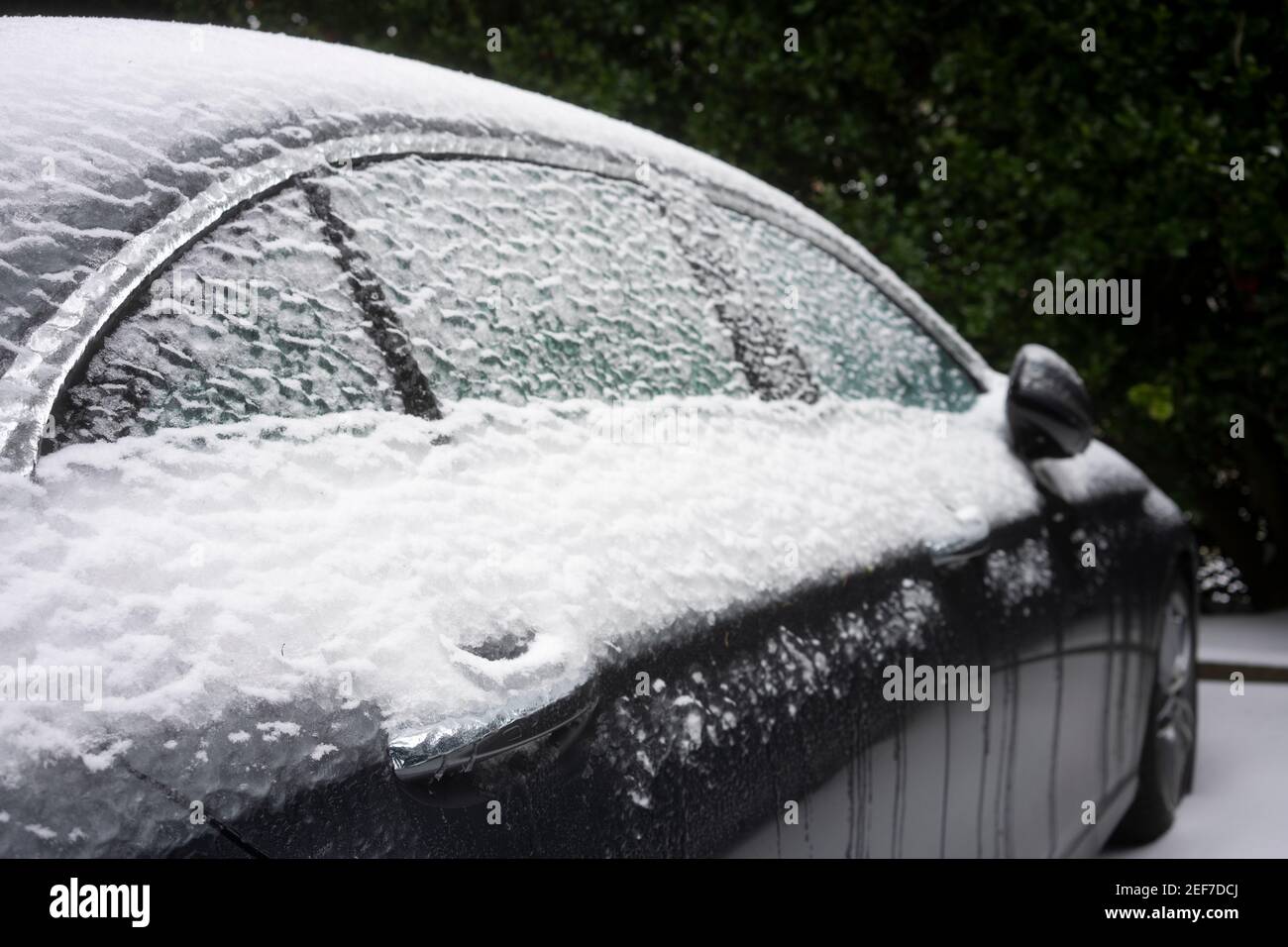 Closeup of the frozen door handle and windows of a car on the streets