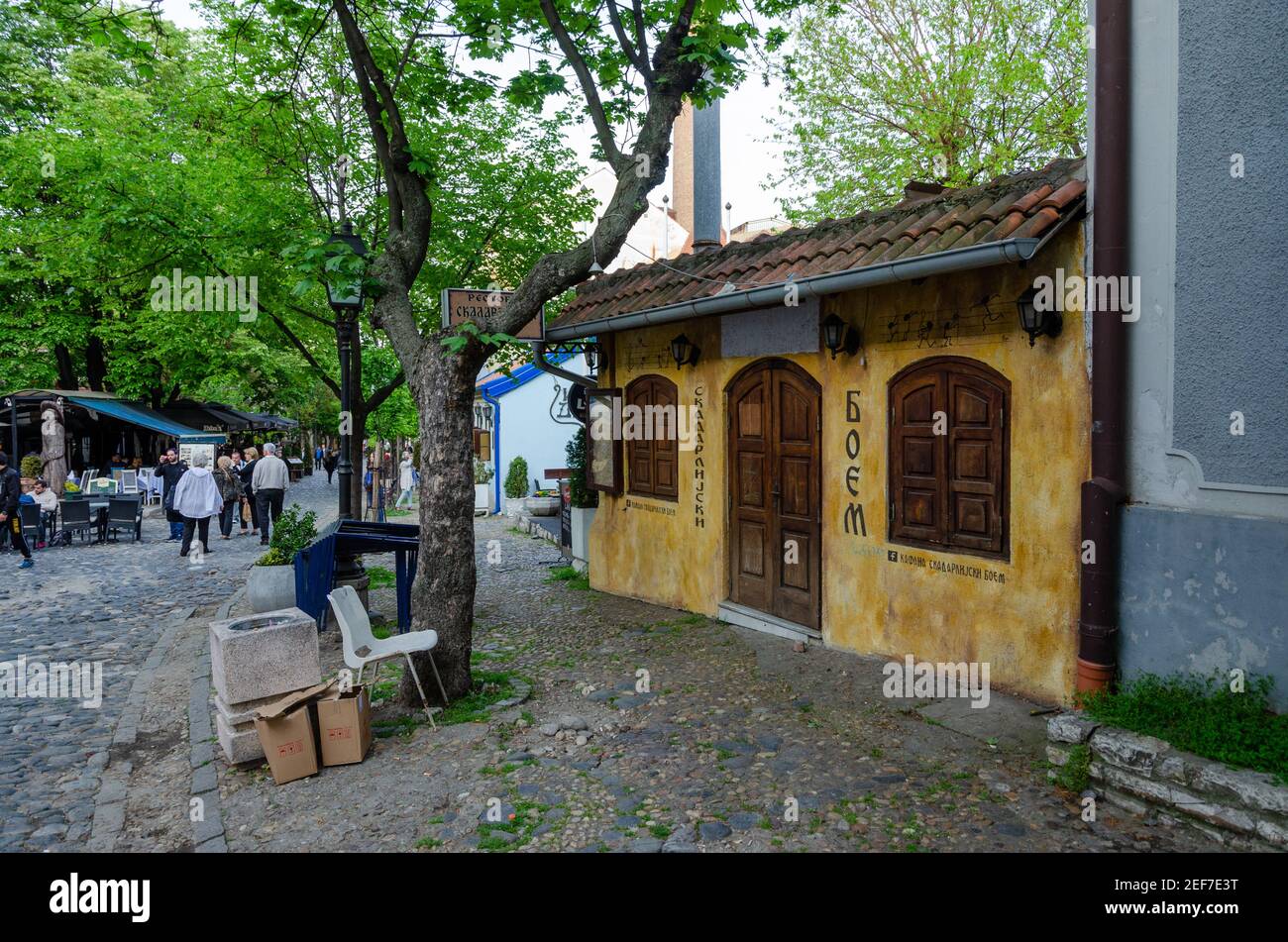 Belgrade historic place Skadarlija with trees, cafes, cobbled lanes and alleys in downtown. Bohemian street with bars and restaurants. Stock Photo