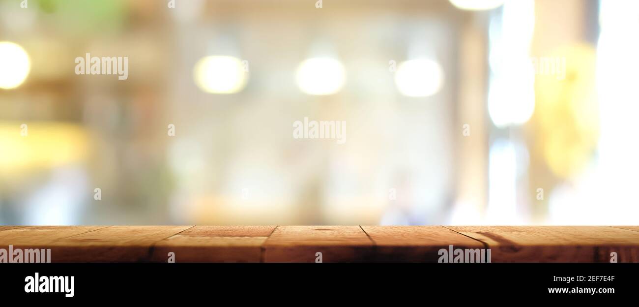 Wood table top on blur restaurant interior background, panoramic banner - can be used for display your products (or food) Stock Photo