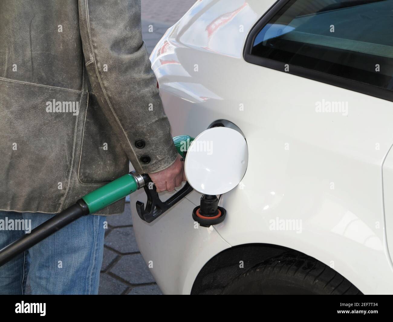 Close up of male hand topping up car tank Stock Photo