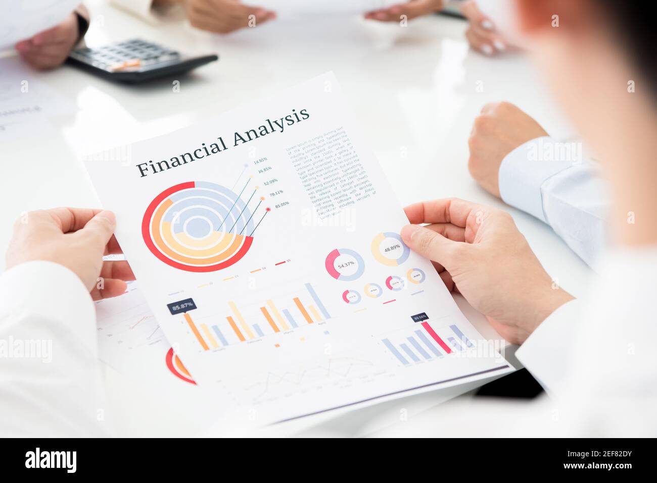 Businessman analyzing financial graph document at the meeting Stock Photo