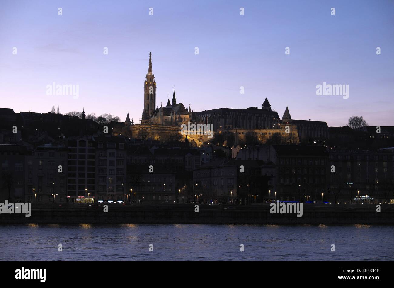 St Matthias Church and Fisherman's Bastion, seen over River Duna (Danube) at night, Budapest, Hungary. Stock Photo