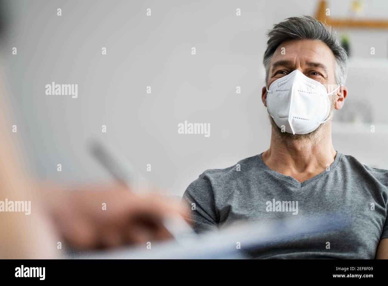 Psychiatrist Or Psychology Psychologist With Clipboard And Face Mask Stock Photo