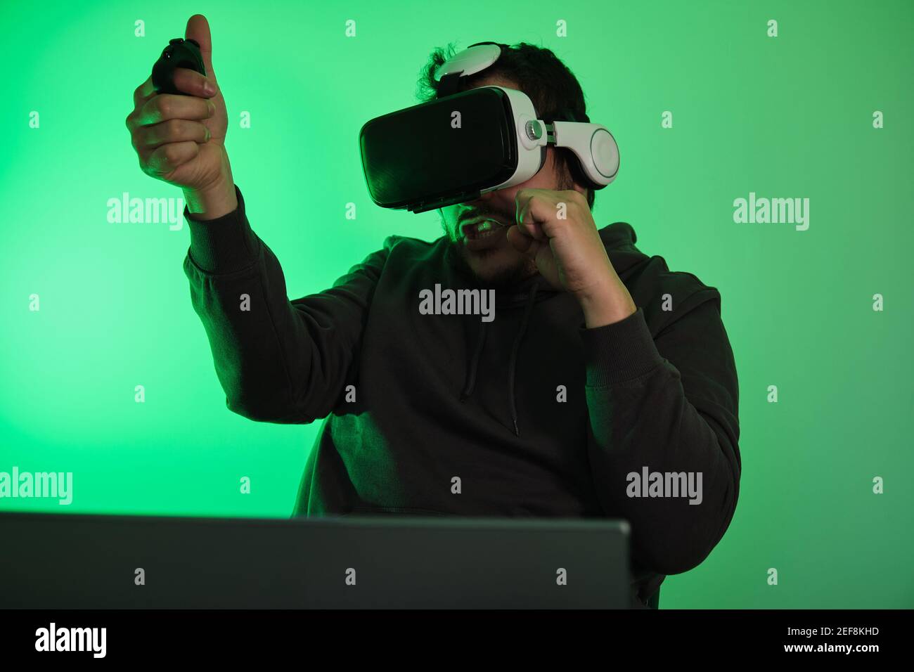 Gamer wearing virtual reality goggles, fighting and playing video games