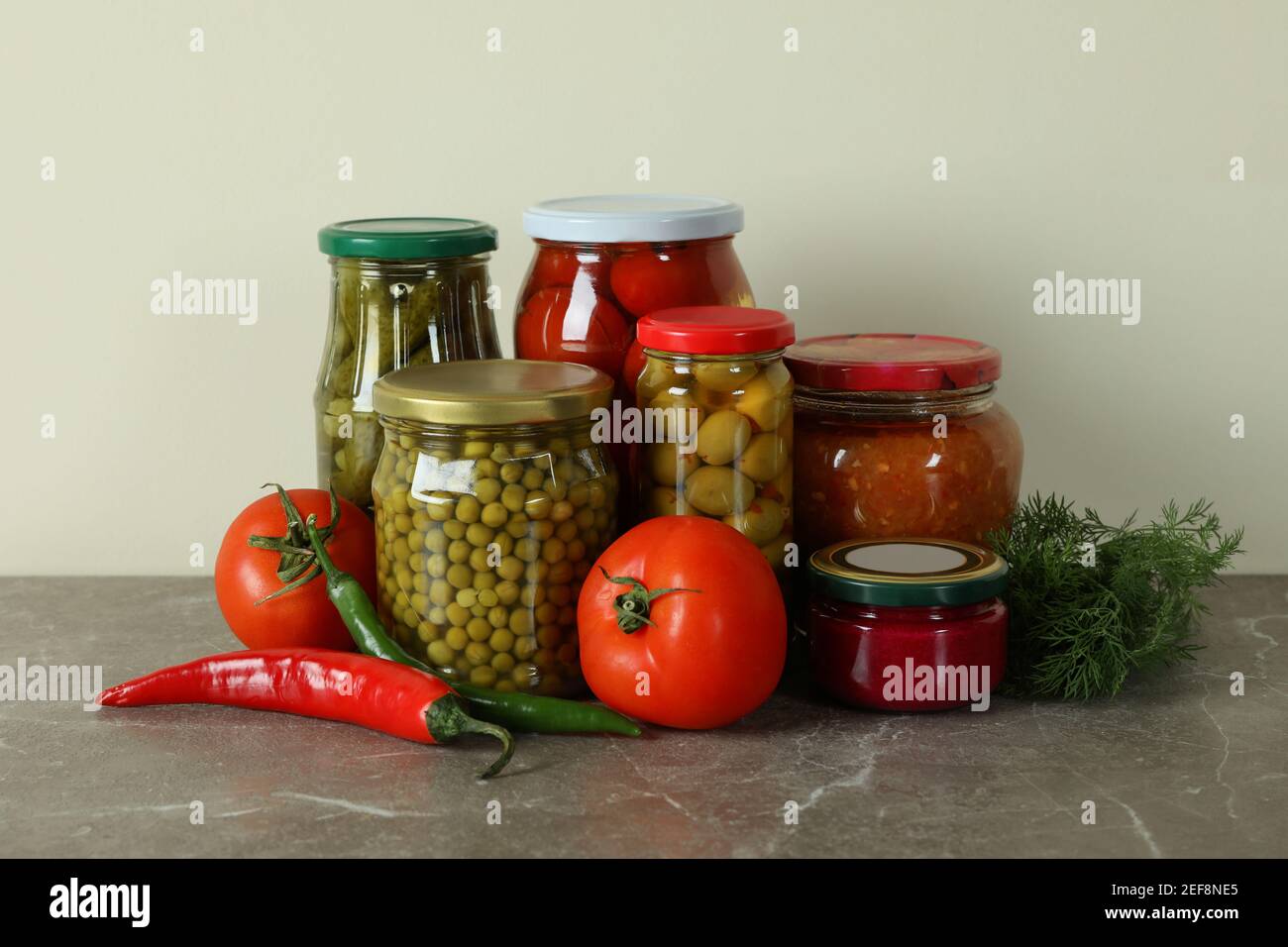 Jars with different pickled food on gray table Stock Photo Alamy